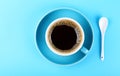 Full cup of black coffee and saucer over blue Royalty Free Stock Photo