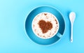 Full cup of latte cappuccino coffee on blue paper Royalty Free Stock Photo