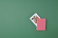 Full deck of playing cards on green background. Cards of Queen of spades are visible from deck. Top view. Copy space. Royalty Free Stock Photo