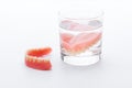 Full Denture in glass of water on white background Royalty Free Stock Photo