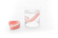 Full Denture in glass of water on white background Royalty Free Stock Photo