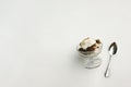 A full dish of ice cream with a spoon at close view sitting on fresh fallen snow so that you have text space.
