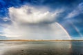 Full double rainbow over a lake Royalty Free Stock Photo