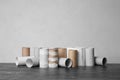 Full and empty toilet paper rolls on table against grey background Royalty Free Stock Photo