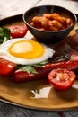 Full English breakfast with bacon, sausage, fried egg, baked beans Royalty Free Stock Photo