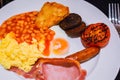 Full English Breakfast with Bacon, Sausage, Fried Egg, Beans, Scrambled Eggs, Hash Browns and Black Pudding. Royalty Free Stock Photo