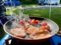 Full English breakfast cooking outside on camping site. Summer Scene. Royalty Free Stock Photo