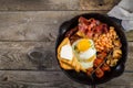 Full english breakfast - eggs, bacon, beans, toast, coffee and juice Royalty Free Stock Photo