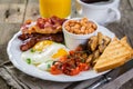 Full english breakfast - eggs, bacon, beans, toast, coffee and juice Royalty Free Stock Photo