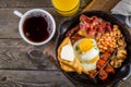 Full english breakfast - eggs, bacon, beans, toast, coffee and juice Royalty Free Stock Photo