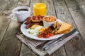 Full english breakfast - eggs, bacon, beans, toast, coffee and juice Royalty Free Stock Photo