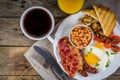 Full english breakfast - eggs, bacon, beans, toast, coffee and juice Royalty Free Stock Photo