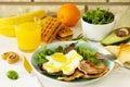 Full  English breakfast - fried egg, fried bacon, spinach, arugula, avocado, toast and orange juice Royalty Free Stock Photo