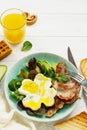 Full English breakfast - fried egg, fried bacon, spinach, arugula, avocado, toast and orange juice. Royalty Free Stock Photo