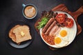 Full English Breakfast with Latte Art on dark table Royalty Free Stock Photo