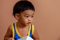 A Full Face of Adorable toddler Asian baby boy 2-year-old Enjoys Playing and Holding a Paper Box by Self with Blurry Background Royalty Free Stock Photo