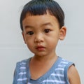 A Full Face of Adorable toddler Asian baby boy 1-year-old Looking Camera with Sloppy mouth from eating food, Self Outdoor