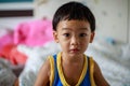 A Full Face of Adorable toddler Asian baby boy 2-year-old Relaxing and Looking Camera in the Room with Blurry Background, Home Royalty Free Stock Photo