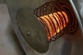 Full-face of an old reflex heater with the heated spiral it is isolated on the black. Royalty Free Stock Photo