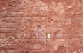 Artsy looking old salmon color painted brick wall texture with deterioration