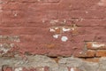 Artsy looking old salmon color painted brick wall texture with deterioration