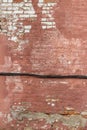 Artsy looking old salmon color painted brick wall texture with deterioration