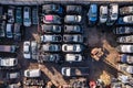 Full frame aerial view directly above scrap yard and rows of scrap metal cars