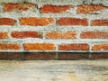 Old Grungy Grainy Wooden Table Top Against Bare Brick Wall