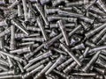 Full frame background of pile of shiny long steel parts, clean steel rods after fine cnc turning - laying chaotically Royalty Free Stock Photo