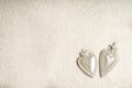 Full frame background of two white hearts on a seamless detailed lace pattern on white background with copy space