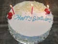 White birthday cake with lit candles Royalty Free Stock Photo