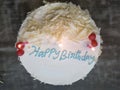White birthday cake with lit candles Royalty Free Stock Photo