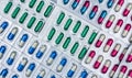 Full frame of colorful capsule pills in blister pack arranged with beautiful pattern. Pharmaceutical packaging. Royalty Free Stock Photo