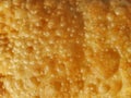 Full frame of crispy fried dough with bubles. Background, texture use