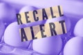 full frame egg recall illustration eggs in carton close-up background with words Royalty Free Stock Photo