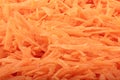 Full frame of a heap of grated carrots. Food background.