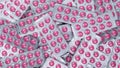 Full frame heap of round pink tablets pills in blister pack. Prescription drugs. Painkiller medicine. Pharmaceutical industry.