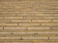 Full frame image of old rough concrete stairs with rows of steps in perspective and traces of yellow paint