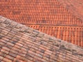 Full frame image of orange terracotta tiled roofs with diagonal traditional pantiles in lines and rows