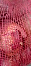 Full frame image of red onions Bright red onions and onions in red mesh bags. Royalty Free Stock Photo