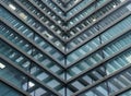 Full frame modern office architecture abstract with geometric angular reflected shapes and lines in blue glass windows