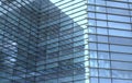 Modern urban office architectural abstract with geometric shapes and buildings reflected in blue glass windows Royalty Free Stock Photo