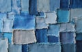 Full-frame patchwork background made of assorted denim and jeans square scraps. The seamless textile pattern features various Royalty Free Stock Photo