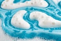 A full frame setting of luxurious cream is depicted, boasting a rotating macro level texture and an opaque blue gel Royalty Free Stock Photo