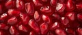 Full frame shot of pomegranate seeds. Abstract photo of a close-up of neatly arranged pomegranate seeds. Background texture of a