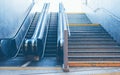 Full frame take of a stone staircase next to a modern escalator