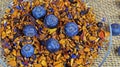 Full frame top view closeup of isolated fresh blueberries on pile dried fruits for fruit tea preparation on transparent glass dish Royalty Free Stock Photo