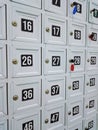 Full frame of white lockers with numbers and colorful key hang for storing visitor shoes Royalty Free Stock Photo