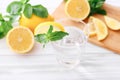 Full glass of fresh cool transparent water with lemon and mint leaves on wooden table Royalty Free Stock Photo