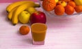 full glass of juice on a background of fresh fruits.